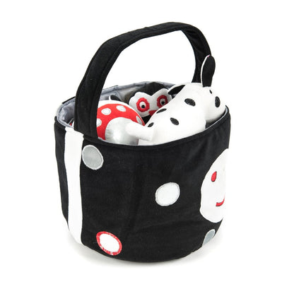 Black and white soft baby toys in basket, contrasting
