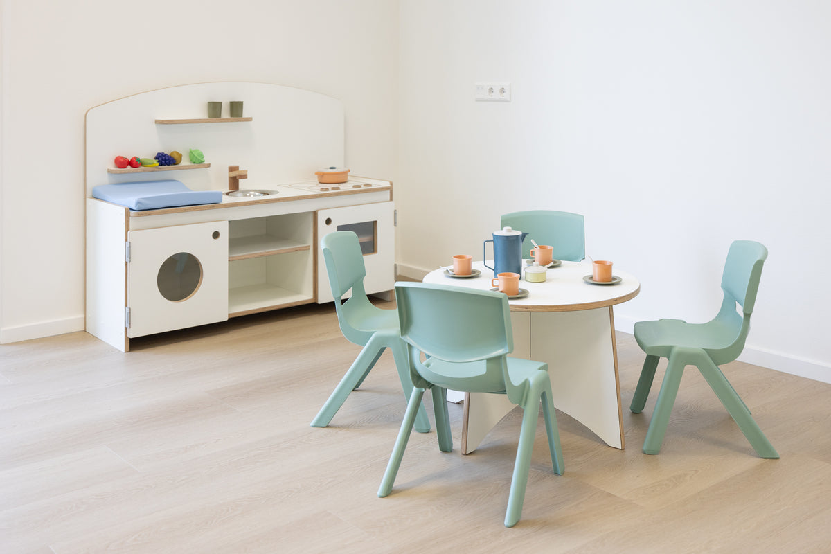 Furnished play area with children's kitchen, table and chairs