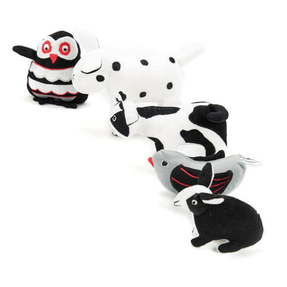 Black and white soft baby toys in basket, contrasting
