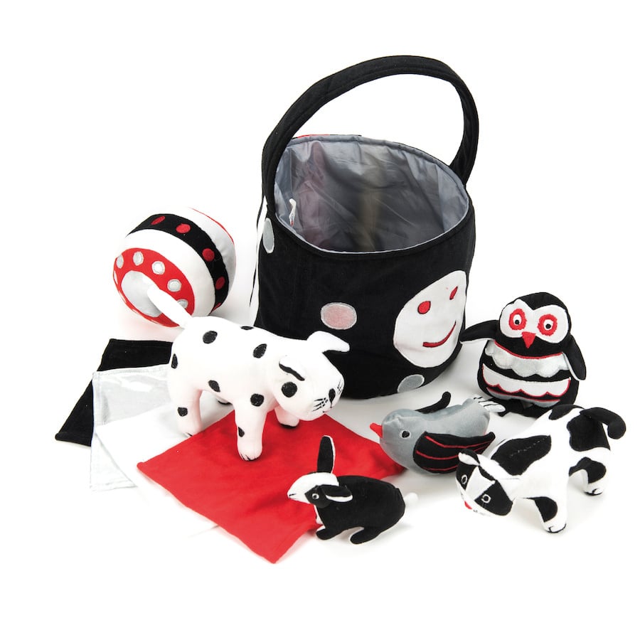 Black and white soft baby toys in basket, contrasting